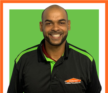 Shecheme, male, SERVPRO employee, cut out, against a white background, SERVPRO green sign above head