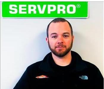 Kevin Biggers, SERVPRO employee male, in front of white background and green servpro sign