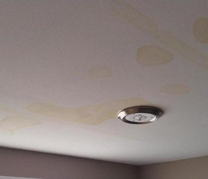 Crack in roof caused water to seep in through a house into room
