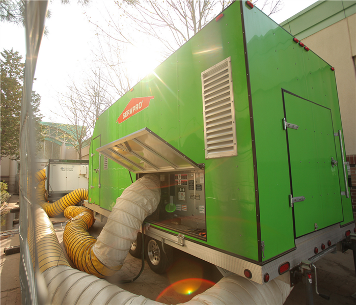 large desiccant dehumidifier with hepa filtration, angled shot from below, green with large tubes, SERPVRO machine