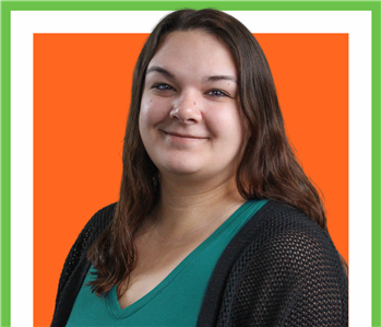 Rayven, servpro employee against a orange background, woman